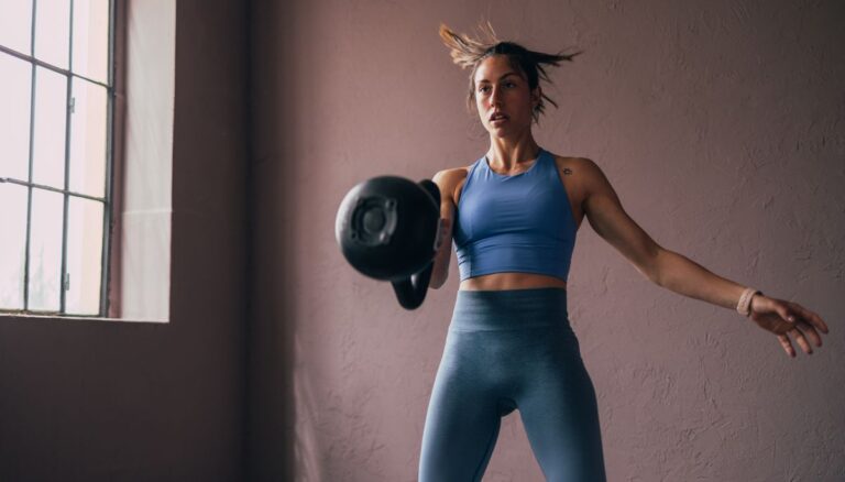 Woman exercises with kettlebell